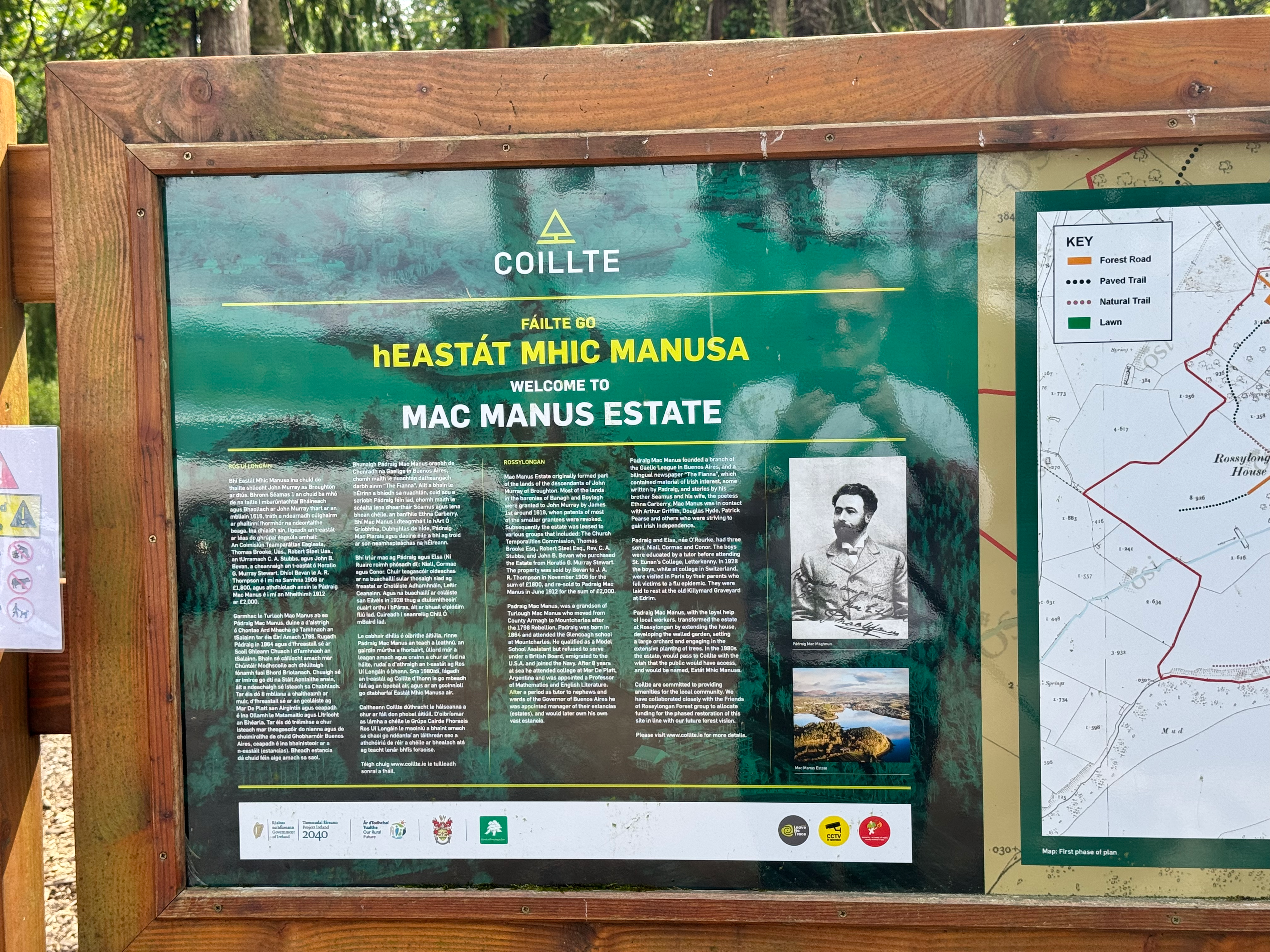 A sign at the entrance of the Mac Manus Estate. The sign is green and is in both Gaelic and English, describing the history of the estate and the grounds which open up on the Atlantic Ocean.